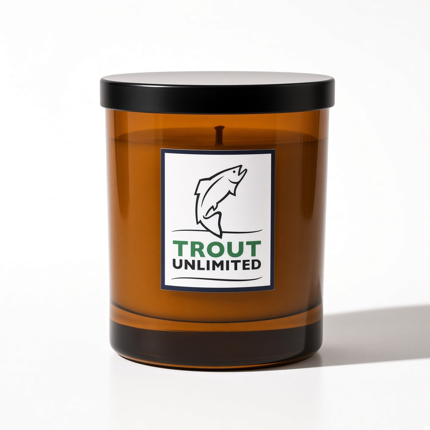 AURA Candle Bar X Trout Unlimited Minted Water Fragranced Candle in an amber vessel with a black lid
