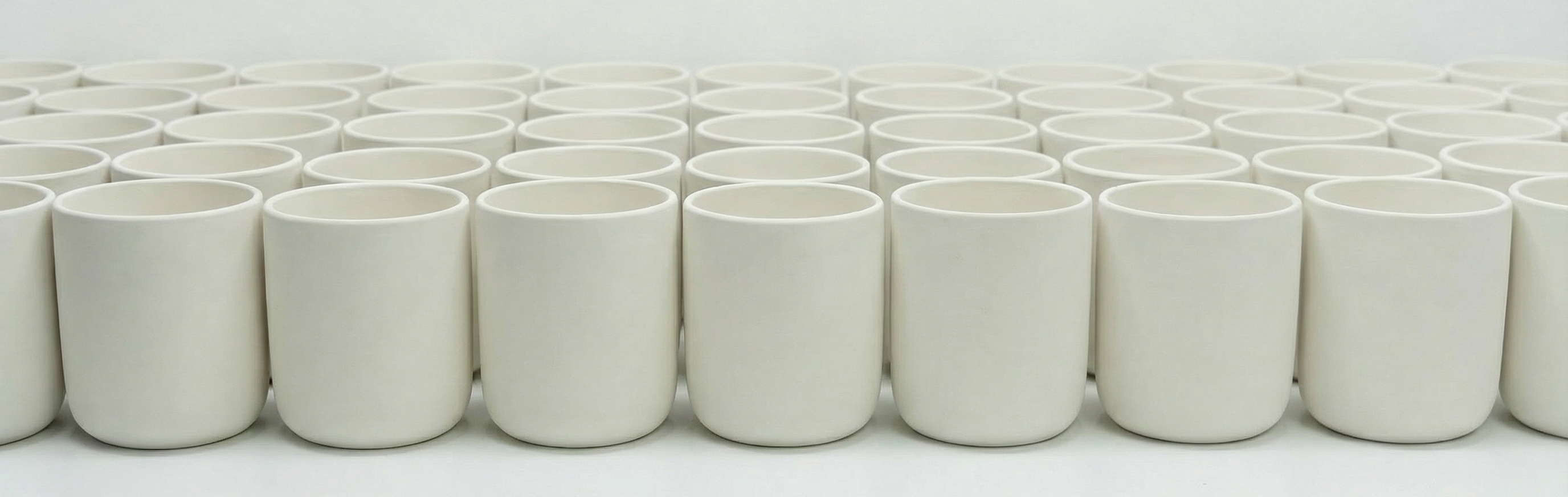 AURA Candle Bar Wholesale Ceramic Vessel options.  White Ceramic vessels arranged on a work surface.
